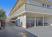Thumbnail 34 of 35 - A street view of a building with a clear blue sky above.