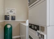 Thumbnail 37 of 37 - A white dishwasher is in a kitchen with a green trash can.