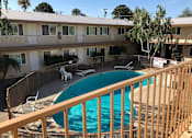Thumbnail 22 of 62 - a view of a swimming pool from a balcony