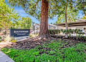 Thumbnail 21 of 41 - A sign for Southwood Apartments is in front of a tree.