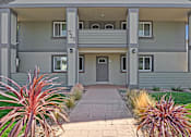 Thumbnail 36 of 37 - The image shows a modern two-story house with a grey exterior and a balcony on the second floor.