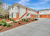 Thumbnail 1 of 29 - A white building with orange stairs and a red door.