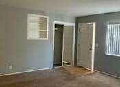 Thumbnail 10 of 37 - A room with a carpeted floor and a white door.