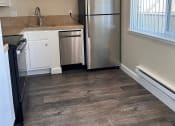 Thumbnail 22 of 36 - a kitchen with a stainless steel refrigerator and a window
