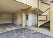 Thumbnail 38 of 63 - A garage with a white door and a brown staircase.