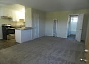 Thumbnail 4 of 14 - A kitchen with a black stove top oven and white cabinets.