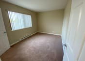 Thumbnail 39 of 51 - an empty room with a window and a door