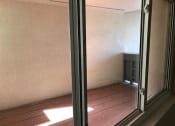 Thumbnail 30 of 31 - an empty room with a window and a wooden floor