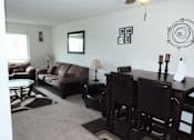 Thumbnail 13 of 15 - A living room with a couch, chairs, and a table.