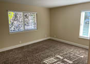 Thumbnail 33 of 43 - A room with a carpet on the floor and a window with blinds.