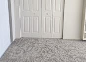 Thumbnail 14 of 42 - A room with a white door and a grey carpet.