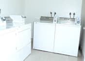 Thumbnail 15 of 15 - A white cabinet with a microwave on top of it.