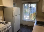 Thumbnail 24 of 31 - a kitchen with a refrigerator and a window