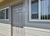 Thumbnail 13 of 32 - A grey door with a number 8 on it is on a house.