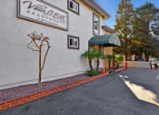 Thumbnail 3 of 35 - A sign for Villa Mead Apartments is on the side of a building.