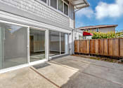 Thumbnail 44 of 53 - a sliding glass door opens to a patio outside of a house
