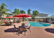 Thumbnail 12 of 16 - Swimming Pool Area With Shaded Chairs at Ranchero Plaza, San Jose, CA