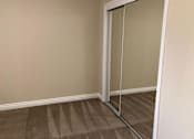 Thumbnail 38 of 62 - a closet with a pair of mirrored closet doors