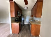 Thumbnail 32 of 51 - a kitchen with wooden cabinets and a stove and a sink