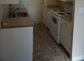 Thumbnail 31 of 31 - an empty kitchen with a stove and a sink