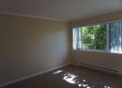 Thumbnail 13 of 31 - an empty living room with a large window
