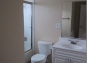 Thumbnail 20 of 31 - a white bathroom with a toilet and a sink