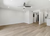 Thumbnail 51 of 92 - A room with a ceiling fan and wooden flooring.