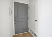 Thumbnail 85 of 92 - A white door is open to a hallway.