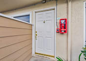 Thumbnail 33 of 51 - A red fire extinguisher is mounted on a wall next to a white door.