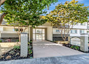 Thumbnail 5 of 43 - The image shows a building entrance with a sign that reads "meirose" and is surrounded by trees and shrubs.