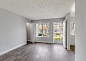 Thumbnail 34 of 40 - A room with a grey wall and a wooden floor.