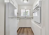 Thumbnail 52 of 52 - A white kitchen with a window and a sink.