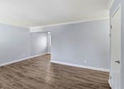 Thumbnail 10 of 17 - A room with a white door and grey walls.