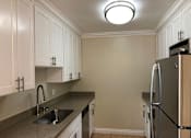 Thumbnail 48 of 62 - a kitchen with a sink and a refrigerator