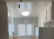 Thumbnail 14 of 37 - A kitchen with a white fridge and a white sink.