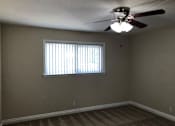 Thumbnail 36 of 62 - a living room with a ceiling fan and a window