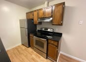 Thumbnail 30 of 51 - a kitchen with stainless steel appliances and wooden cabinets