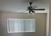 Thumbnail 8 of 14 - a empty room with a ceiling fan and a window
