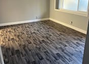 Thumbnail 3 of 14 - a room with wood flooring in an empty room