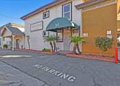 Thumbnail 2 of 35 - A building with a green awning and the number 112 on it.