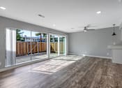Thumbnail 43 of 53 - a living room with a sliding glass door to a deck