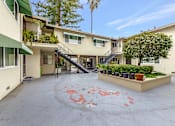 Thumbnail 23 of 43 - A courtyard with a red circle painted on the ground.