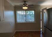Thumbnail 13 of 62 - an empty kitchen with a ceiling fan and a window
