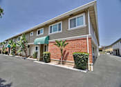 Thumbnail 18 of 62 - a building with palm trees in front of it