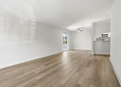 Thumbnail 74 of 92 - A room with wooden floors and white walls.