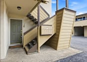 Thumbnail 60 of 63 - A staircase with a grey door is attached to a building.