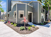 Thumbnail 17 of 41 - A modern house with a grey exterior and a small garden in front.