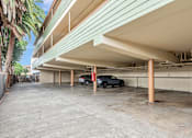 Thumbnail 12 of 14 - A parking garage with a car parked in the middle.