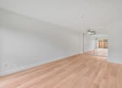 Thumbnail 43 of 51 - A room with wooden flooring and white walls.