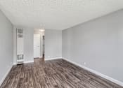 Thumbnail 19 of 40 - A room with wooden flooring and white walls.